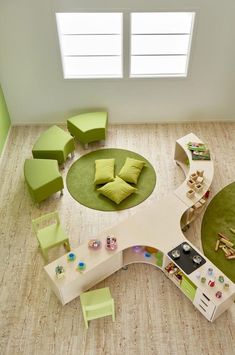 an overhead view of a living room with green furniture and rugs on the floor