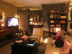 a living room filled with furniture and christmas lights