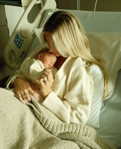 a woman in a hospital bed holding a baby