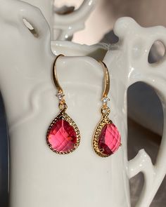 The Ruby Drop Earrings perfect for the Holiday season. Parisian vibes and perfect for for that Little Black Dress! Ruby Glass drops with gold plated brass 12x19mm and gold plated ear wire with cubic zirconia 16mm. Elegant 14k Gold-filled Red Jewelry, Elegant Red Gold Jewelry, Red 14k Gold Filled Drop Earrings, Red Gemstone Gold-plated Earrings, Red Gemstone Gold Plated Earrings, Red Gold Plated Earrings For Party, Red 14k Gold Filled Earrings For Gift, Red Gold Plated Drop Earrings, Elegant 14k Gold Filled Earrings For Valentine's Day