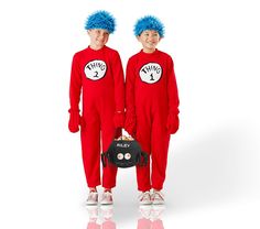 two children in red onesuits with blue hair standing next to each other