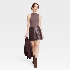 Refresh your separates closet as the seasons change with the Mock Turtleneck Tank Bodysuit from A New Day™. This sleeveless pull-on tank bodysuit is designed in elegant solid hues for a sophisticated look, and it features a mock turtleneck neckline for additional flair. The bodysuit is made from a soft and stretchy cotton-blend fabric to give you a comfortable fit that moves with you, and it boasts a full-coverage bottom with metal snaps at the crotch for added convenience and confident wear. We Chic Brown Bodysuit For Fall, Chic Fall Bodysuit For Workwear, Spring Chic Tank Bodysuit, Chic Fall Workwear Bodysuit, Chic Solid Color Tank Top For Fall, Chic High Neck Tank Top For Fall, Trendy High Neck Tank Top For Fall, Casual Turtleneck Bodysuit For Spring, Trendy Sleeveless Bodysuit For Fall