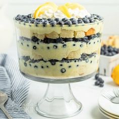 a layered cake with blueberries and lemons on top