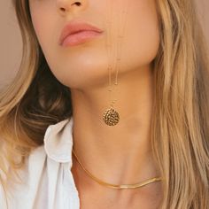 Our Gold Filled Hammered Coin Necklace features a hammered gold coin pendant on a beaded chain. Our 14k gold-filled jewelry is bonded with 14k gold and is water and tarnish resistant. 14k gold-filled jewelry is a great alternative to solid gold, and can be worn by people with sensitive skin. - 14k gold-filled- Circle circumference: 16.2 mm. - Adjustable chain length: 17 in - 19 in.- Waterproof, tarnish resistant & hypoallergenic Everyday Hammered Medallion Jewelry, 14k Gold-filled Yellow Gold Round Disc Necklace, 14k Gold Filled Coin Pendant Jewelry, Hammered Gold-plated Medallion Necklace, Gold Plated Hammered Coin Necklace With Round Pendant, Gold Hammered Brass Coin Necklace, Gold Hammered Round Medallion Necklace, Everyday Hammered Gold Plated Necklace, Everyday Hammered Gold-plated Necklace