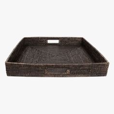 a brown wicker tray with handles