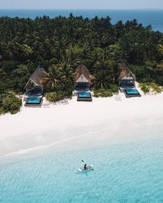 an aerial view of a beach with two people in the water