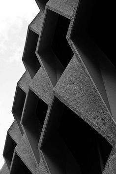 a black and white photo of an abstract building