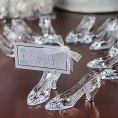 glass shoes are sitting on a table with a name tag in front of them that says, mr and mrs smith