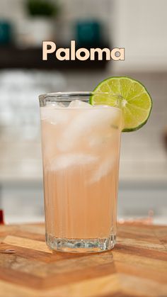 a tall glass filled with ice and lime