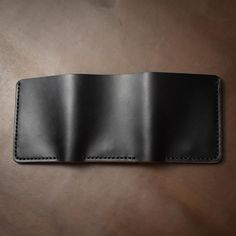 This is a substantial leather trifold wallet.When you're out for dinner with friends, they will notice when you throw this wallet on the table. A loud thud followed by eyes fixed on this beautifully constructed piece will make an impression. Immaculate hand-stitching and full-grain Horween leather compliment a smartly designed, but hefty wallet.This full-grain Horween leather wallet is designed to hold a lot of cards and a lot of cash. Easily flip out your ID when it's needed and the wallet will Full Grain Leather Wallet, Horween Chromexcel, Leather Trifold Wallet, Engraved Initials, Horween Leather, Flip Out, Dinner With Friends, Personalized Keychain, Black Hand