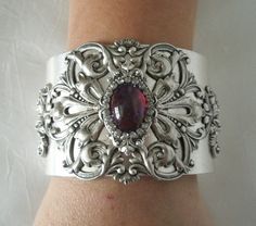 "This beautiful silver plated cuff bracelet has a silver plated floral design and a glass dragon's breath fire opal setting with rhinestone accents. 2\" wide. Adjustable." Victorian Silver Bracelets With Jewels, Ornate Silver Jeweled Bracelets, Ornate Silver Bracelet With Jewels, Ornate Silver Bracelets With Jewels, Elegant Silver Cuff Bracelet With Jewels, Victorian Style Silver Party Bracelets, Vintage Silver Cuff Bracelet For Party, Handmade Victorian Silver Cuff Bracelet, Victorian Style Handmade Silver Cuff Bracelet