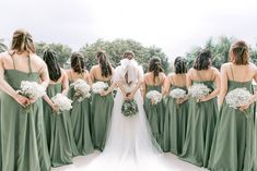 a bride and her bridal party in green dresses