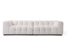 a white couch sitting on top of a wooden floor