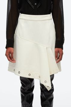 A deconstructed take on utilitarian styles, this A-line mini skirt is crafted from cotton twill and falls to an asymmetric hem. A row of polished silver-tone eyelets frames the silhouette. Cotton twill High waist Asymmetric mini-length hem with eyelet embellishment Silver-tone metal hardware Concealed zip back fastenin Modern Skirt With Asymmetrical Hem For Spring, Modern Asymmetrical Hem Skirt For Spring, Chic Asymmetrical Cotton Skirt, Chic Cotton A-line Mini Skirt, Knit Swimwear, Utility Skirt, Eyelet Skirt, Utilitarian Style, A Line Mini Skirt