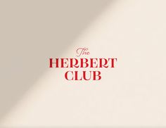 the herbet club logo on a white wall