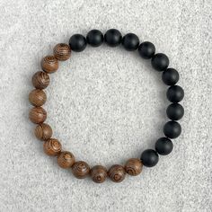 Men's beaded bracelet features: ~ 8mm or 10mm Matte Onyx beads ~ 8mm or 10mm Wenge Wood beads ~ Stretchy cord; simply slide bracelet on and off wrist ~ Comes packaged in a re-usable microfiber pouch To ensure the perfect fit, please use the bracelet sizing instructions found in the photo gallery. Wooden Beaded Bracelets, Wenge Wood, Slide Bracelet, Wood Bracelet, Mens Beaded Bracelets, Onyx Bead, Beaded Stretch Bracelet, Earthy Tones, Bracelet Gift