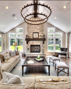 a living room filled with furniture and a fire place in the middle of a room