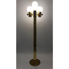 a lamp that is on top of a metal pole with three lights in the middle