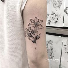 a black and white flower tattoo on the arm