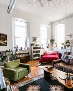 a living room filled with furniture and lots of windows