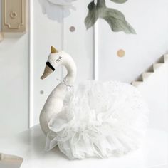 a white swan figurine sitting on top of a table