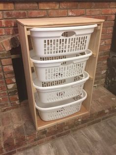 three baskets stacked on top of each other in front of a brick fireplace