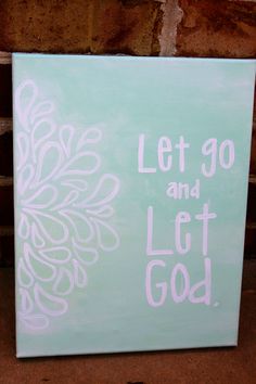 a painting that says let go and let god in white on a light green background