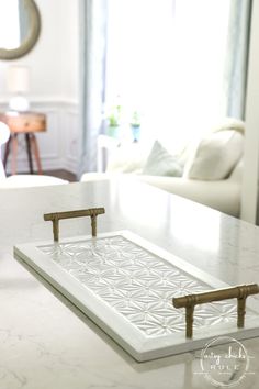 a white marble counter top in a living room with a mirror on the wall behind it