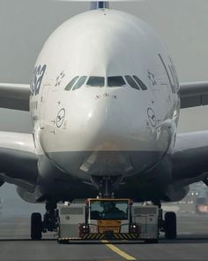 an airplane is being loaded with luggage on the tarmac by a truck that has it's door open