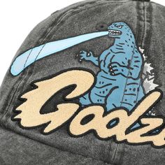 Its Godzilla! Rep your favorite misunderstood monster in this one-of-a-kind cap. The main attraction is the large, bright embroidery and printed artwork of Godzilla on the side of the hat, but printed artwork of the Japanese giant on the underbill adds an extra awesome and unexpected surprise! This must-have hat is made of high-quality cotton, so it's soft and breathable for all-day wear at the beach or in a science lab. The traditional adjustable back allows you to achieve a perfectly secure fi Novelty Cotton Baseball Cap One Size, Cotton Baseball Cap With Graphic Print And Curved Bill, Novelty Cotton Baseball Cap One Size Fits Most, Cotton Baseball Cap With Graphic Print, Adjustable Cotton Baseball Cap With Graphic Print, Cotton Hats With Graphic Print, One Size Fits Most, Graphic Print Cotton Hat, One Size Fits Most, Graphic Print Cotton Hat One Size Fits Most, Graphic Print Cotton Hat