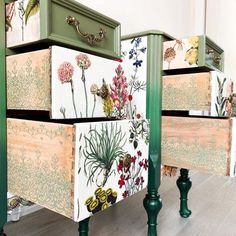 three drawers with flowers painted on them are sitting in front of a wall and floor