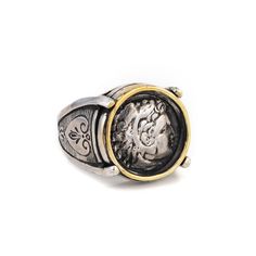 a silver and gold ring with an image of a man's head on it