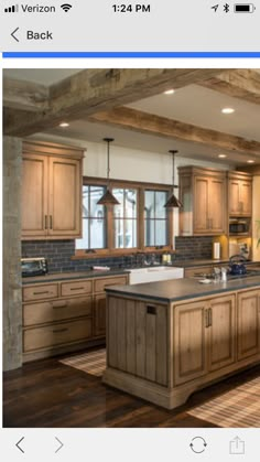 an image of a kitchen with wood cabinets and granite counter tops on the phone screen