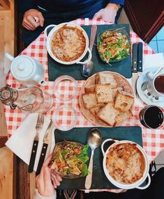 people sitting at a table with food and drinks