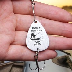 a man is holding a fishing hook with the caption until we fish again dad