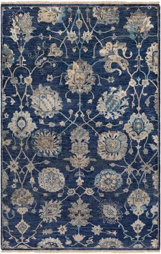 a blue rug with various floral designs on the front and back, all in different colors