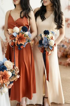 two women standing next to each other holding bouquets