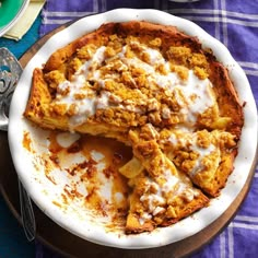 a pie with some toppings on top of it sitting on a plate next to a fork