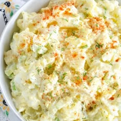 a bowl filled with mashed potatoes and garnished with seasoning on top