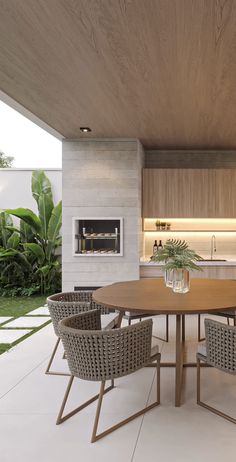 a dining table with chairs around it in the middle of a kitchen and living room