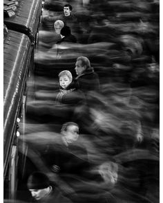 black and white photograph of people sitting on a train