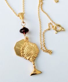 This necklace has two medals, the Eucharist in a monstrance on the front, and a tiny St Mary Magdalene medal on the back. The medals are 18K gold vermeil and topped with a genuine garnet and an 18K gold vermeil bail. The Italian chain is 18 inches long and made of 18K gold vermeil. The necklace was inspired by the 2020 Eucharist Adoration with St Mary Magdalene in Lafayette, Louisiana. Saint Mary Magdalene relics were carried from the South of France, where they reside in the Basilica of Saint M Spiritual Charms Necklaces For Commemoration, Gold Charm Necklaces For Commemoration, Gold Vintage Charm Jewelry For Commemoration, Gold Jewelry With Vintage Charm For Commemoration, Saint Mary Magdalene, St Mary Magdalene, Eucharistic Adoration, Lafayette Louisiana, Maria Magdalena