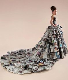 a woman in a dress made out of newspapers