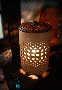 a lit candle sitting on top of a wooden table