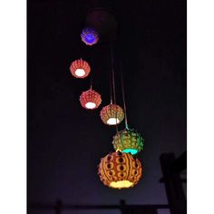 colorful lights hanging from ceiling in dark room