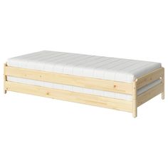 a wooden bed frame with two mattresses on each side and no headboard or foot board