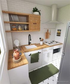 a kitchen with white tile walls and wooden counter tops, along with green rugs on the floor