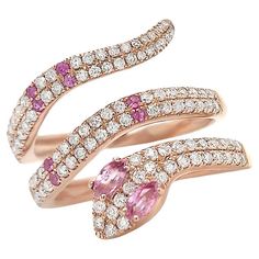 This exquisite serpent-shaped ring is crafted from lustrous 18kt rose gold, adorned with a captivating array of pink sapphires and diamonds. Its sinuous design gracefully coils around your finger, making it a symbol of timeless beauty and enchantment. Ring 18kt Rose Gold Snake with Pink Sapphires 0.26 carats and 115 Round Diamonds 0.74 carats. Size 6. The snake is a powerful symbol representing fertility or a creative life force. Perfect High Jewelry Gift for Mom, Girlfriend, Daughter, Birthday or Christmas Gift. Luxury Rose Gold Sapphire Ring With Pink Sapphire, Luxury Rose Gold Pink Sapphire Ring, Luxury Snake-shaped Diamond Ring, Gold Snake, Sapphire Diamond, Creative Life, High Jewelry, Pink Sapphire, Cocktail Rings