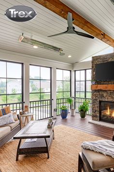 a living room filled with furniture and a flat screen tv mounted on the wall next to a fire place