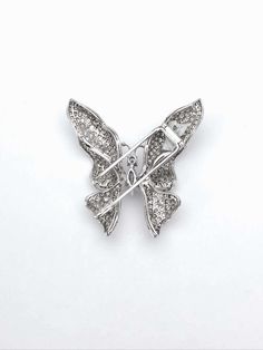 For Sale on 1stDibs - 18 karat white gold butterfly brooch. The butterfly's wings are pave set with round diamonds. The center is set with solitaire round brilliant and marquise Luxury White Butterfly Ring For Formal Occasions, Luxury White Butterfly Ring For Formal Events, Luxury Silver Diamond Butterfly Ring, Elegant Silver Diamond Butterfly Ring, Luxury Diamond Butterfly Ring For Formal Occasions, Luxury White Diamond Brooch, Formal Butterfly Ring With Diamond Accents In Diamond White, Formal Silver Butterfly Ring With Brilliant Cut, Formal Butterfly Ring With Diamond Accents